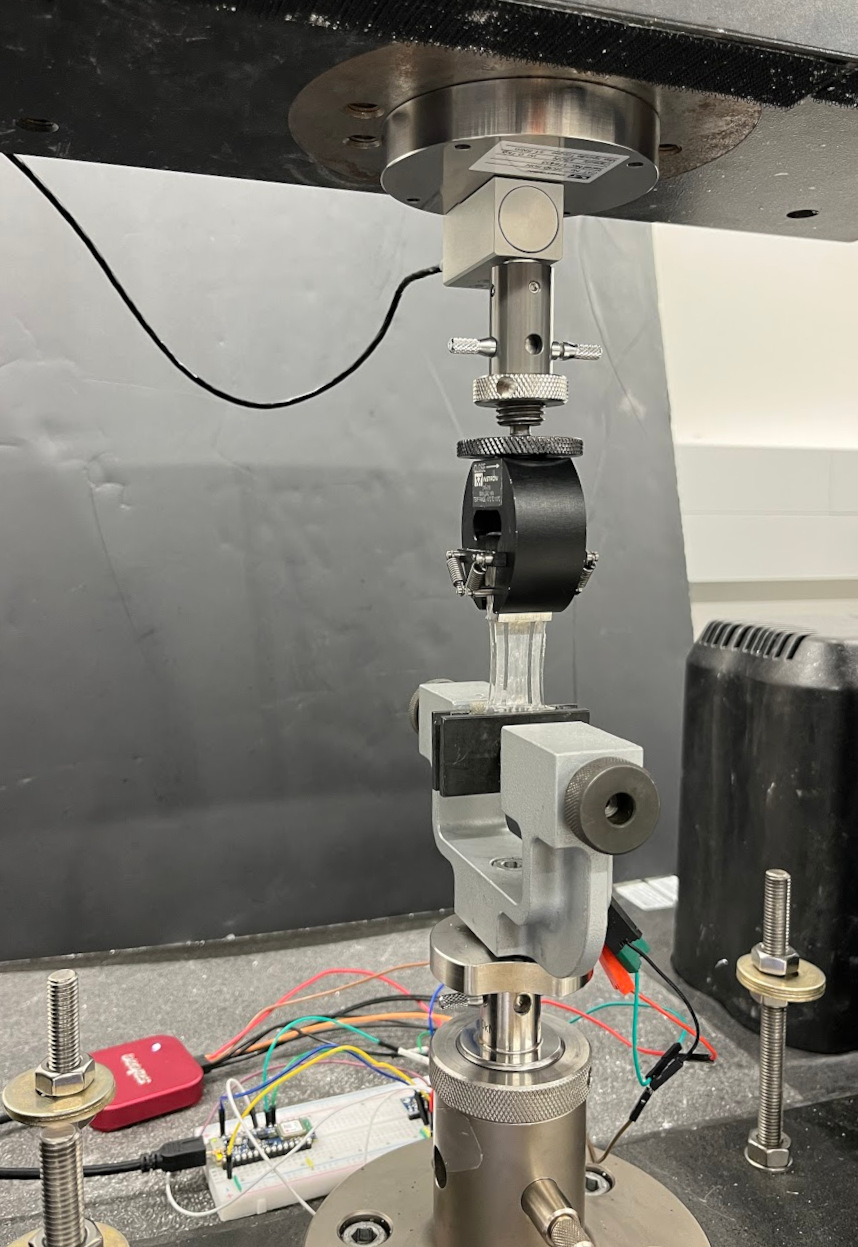 Figure 7. Twin-T sensor in Instron attached to data collection electronics.